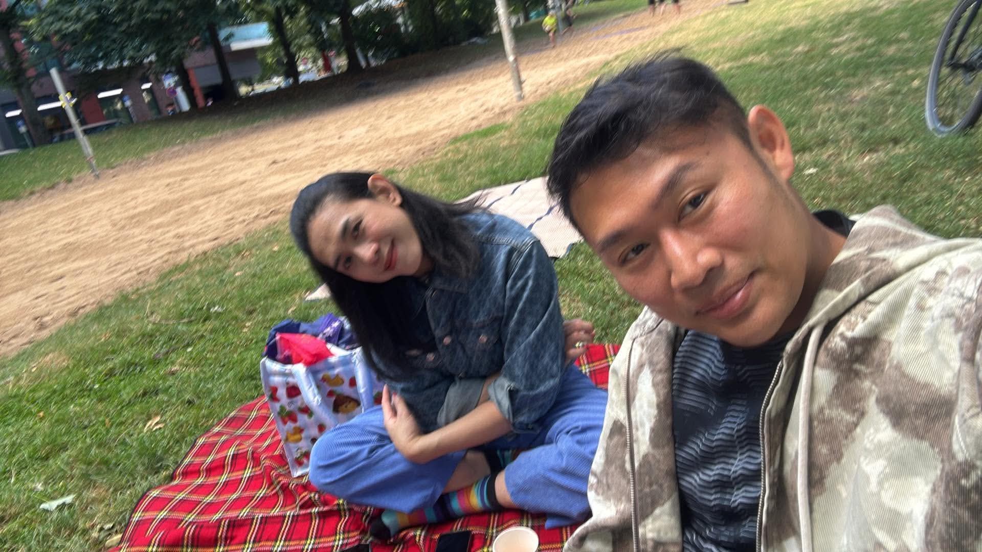 Friends relaxing together on a picnic blanket